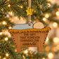 The Gift That Forever Changed the World wooden manger ornament hanging on a Christmas tree