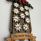 Angled view of personalized wooden family sled Christmas ornament