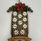 Personalized family sled ornament showing layered wood construction and name snowflakes