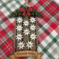 Personalized family sled ornament displayed on Christmas plaid fabric